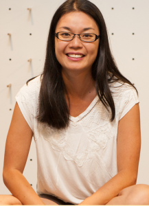 Wai Chim smiling, wearing glasses and wearing a white shirt